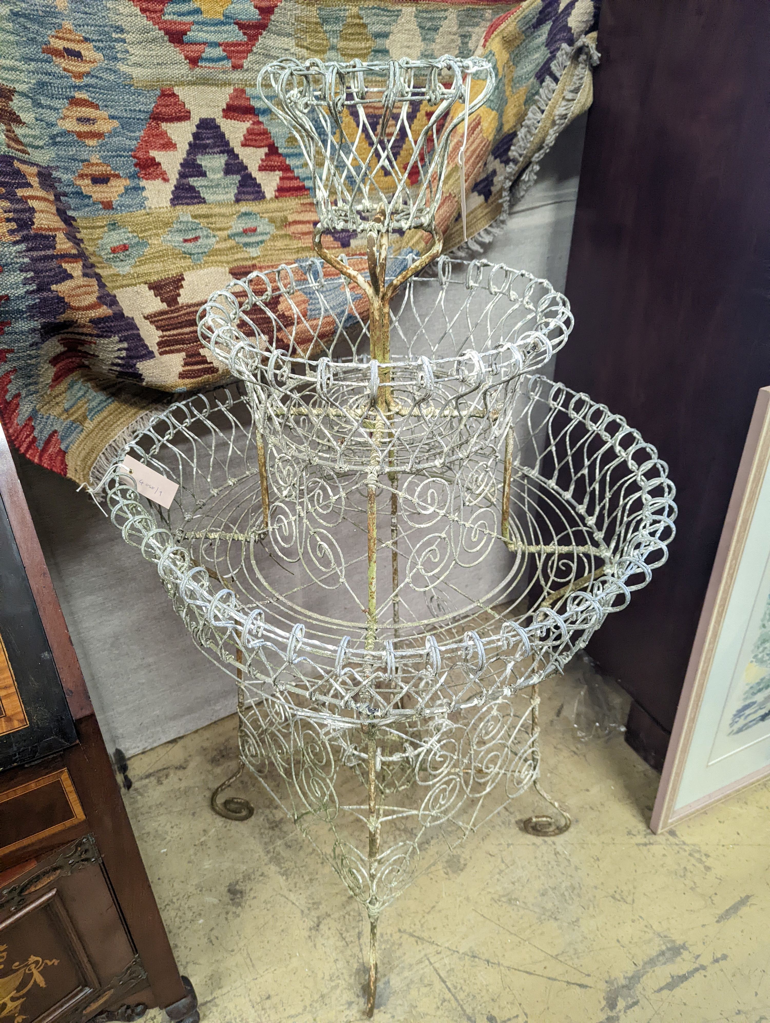 A Victorian painted wirework three tiered plant stand, diameter 65cm, height 112cm
